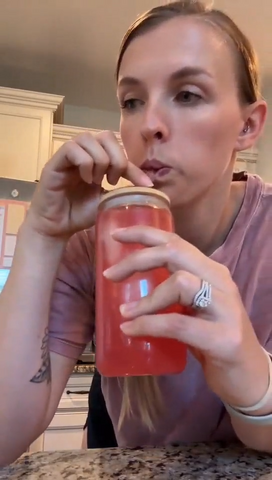Video frame of a customer taking a sip of a Tavo drink.